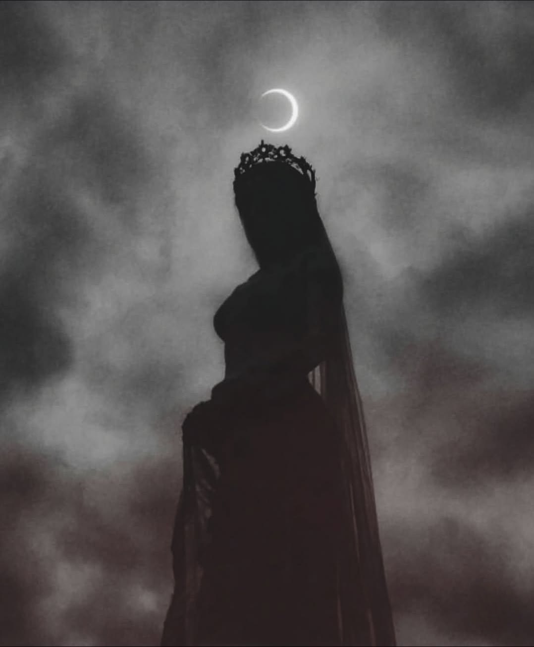 Veiled crowned silhouette standing beneath a glowing crescent moon in a cloudy sky