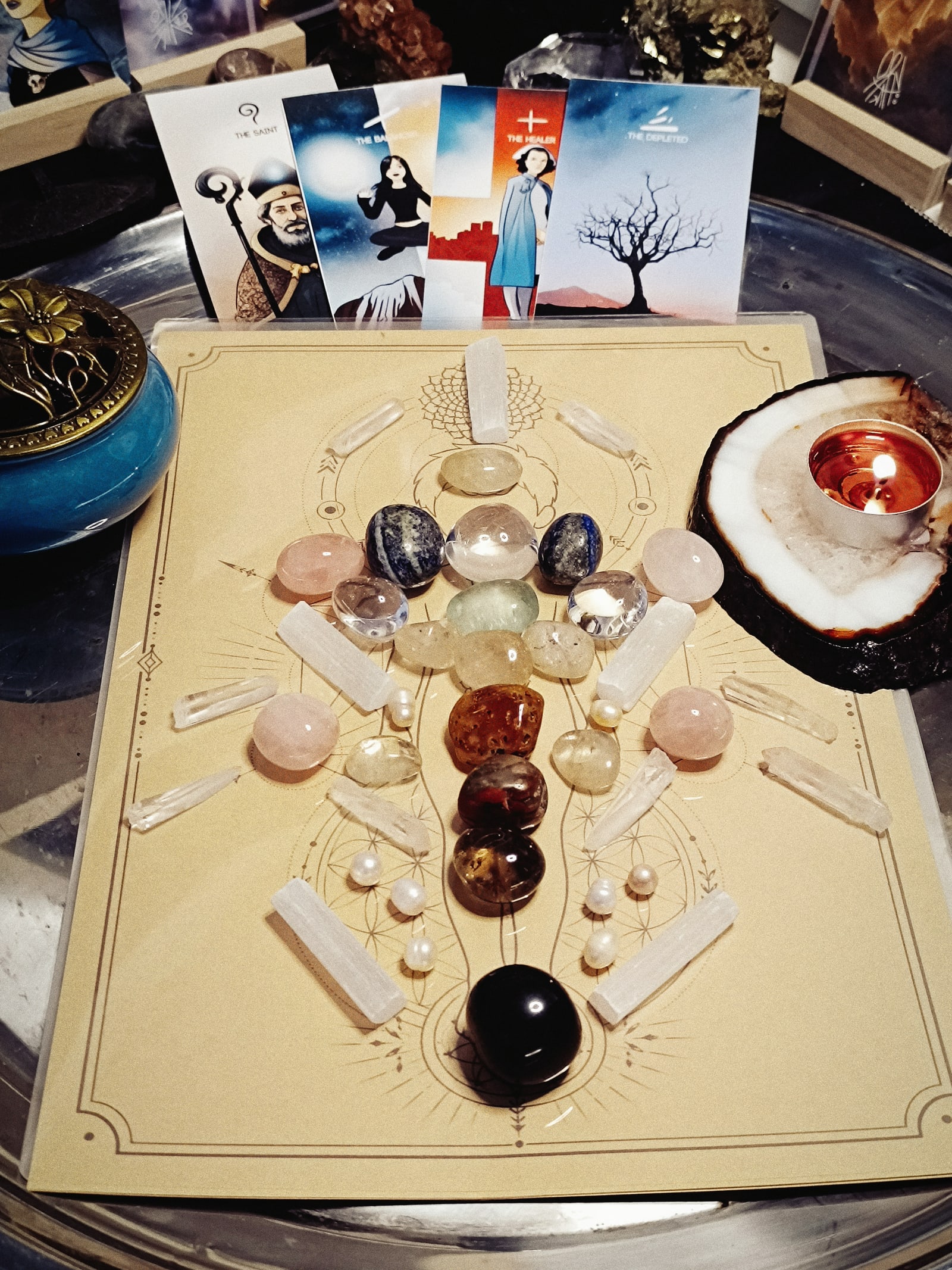 Lucent crystal healing grid arranged with symbolic cards and a candle