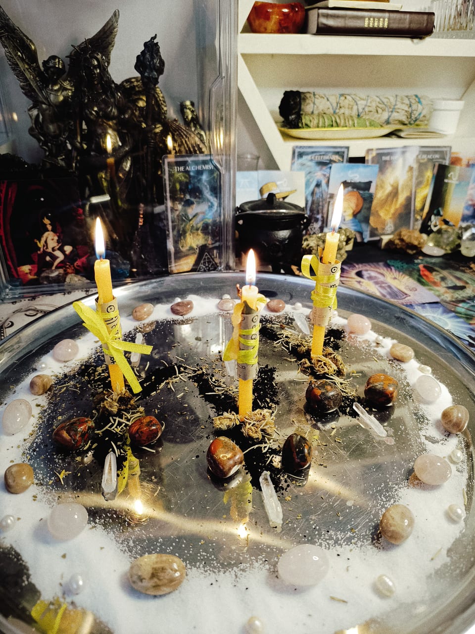 Road Opener candles surrounded by stones and herbs at the Galerie Rberry altar