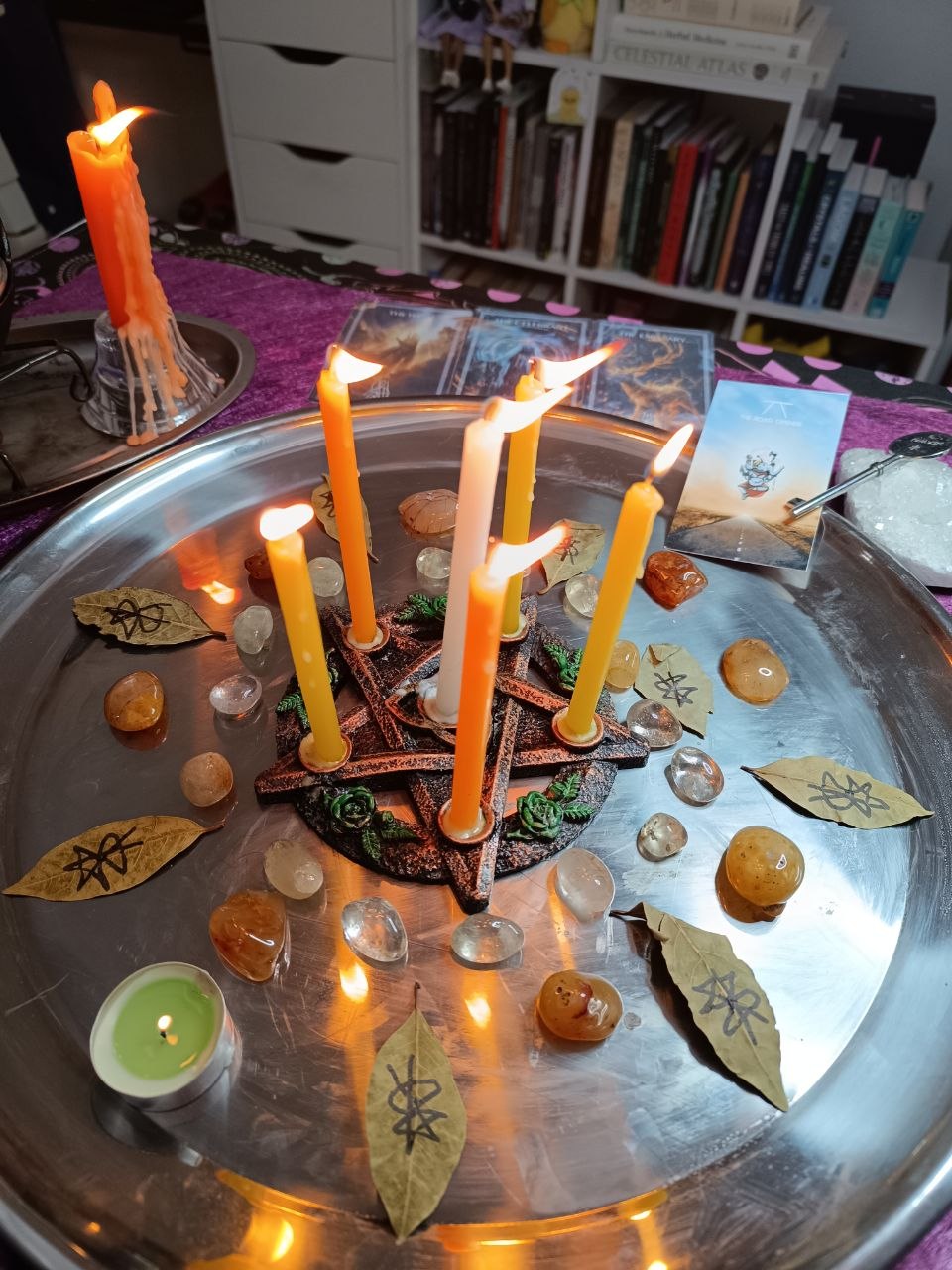 Ritual tray with a pentacle, candle, and tarot spread