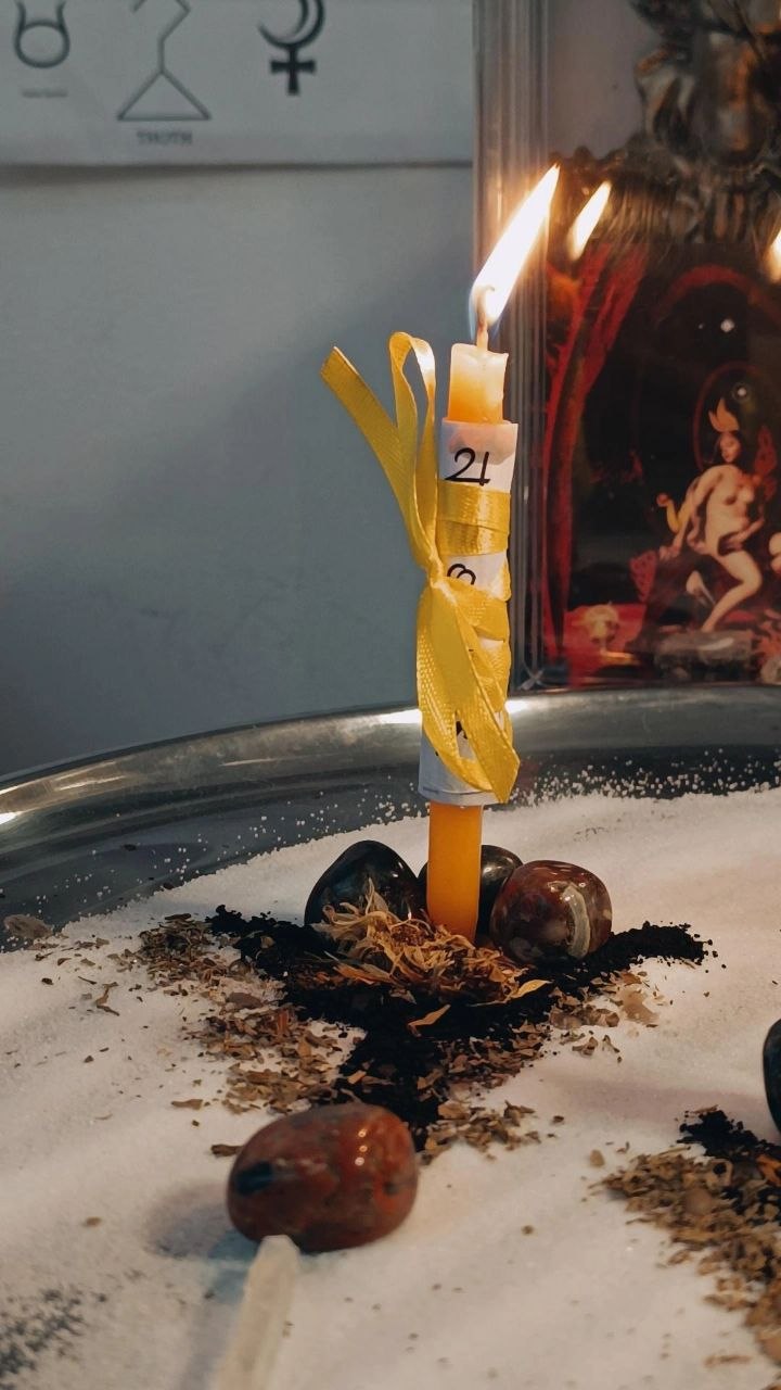 Inscribed ritual candles joined by cord for an unbinding working