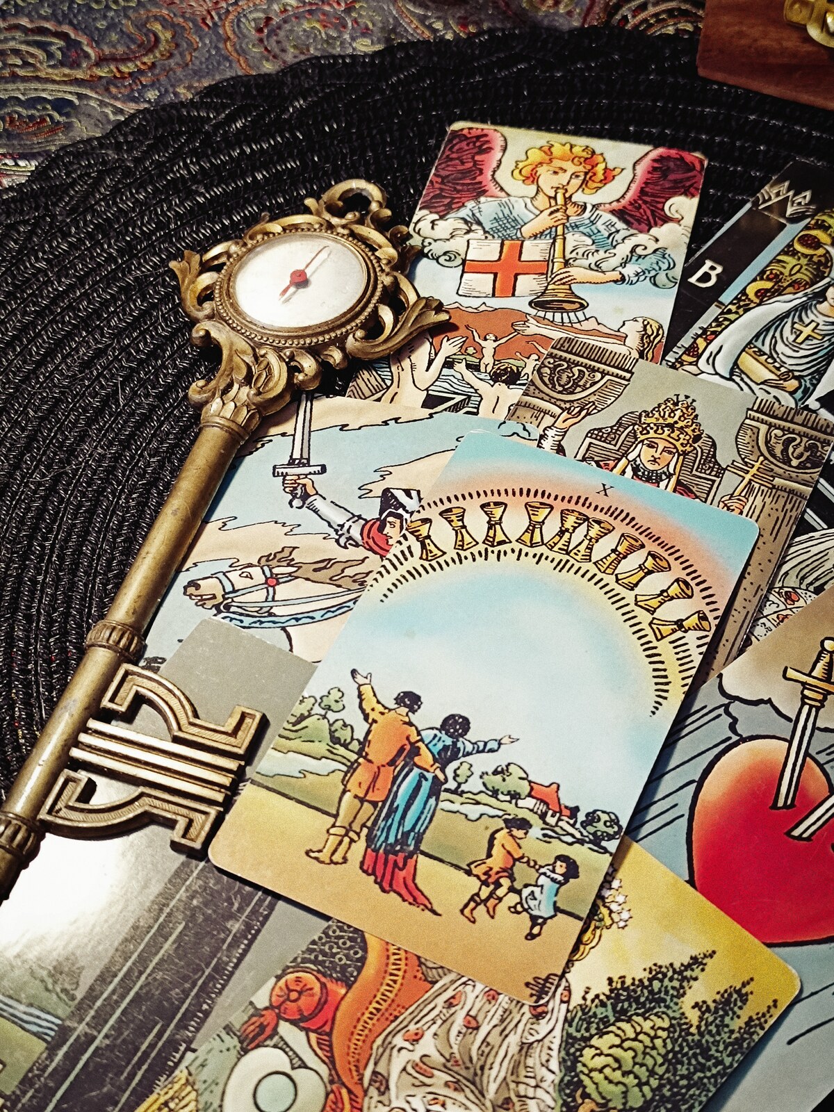 Tarot cards and an ornate brass key arranged for The Future Has Strange Rooms