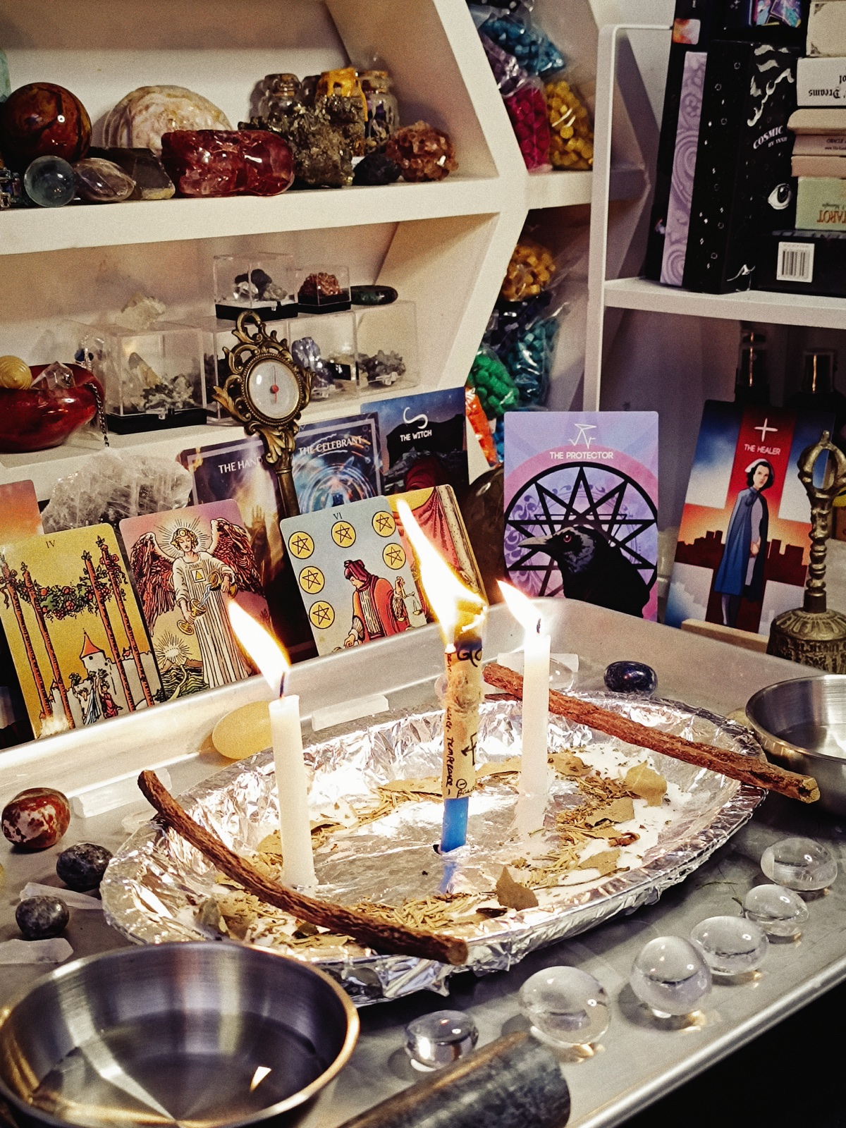 The Temperance Accord ritual burning among tarot cards, crystals, herbs, and balancing bowls