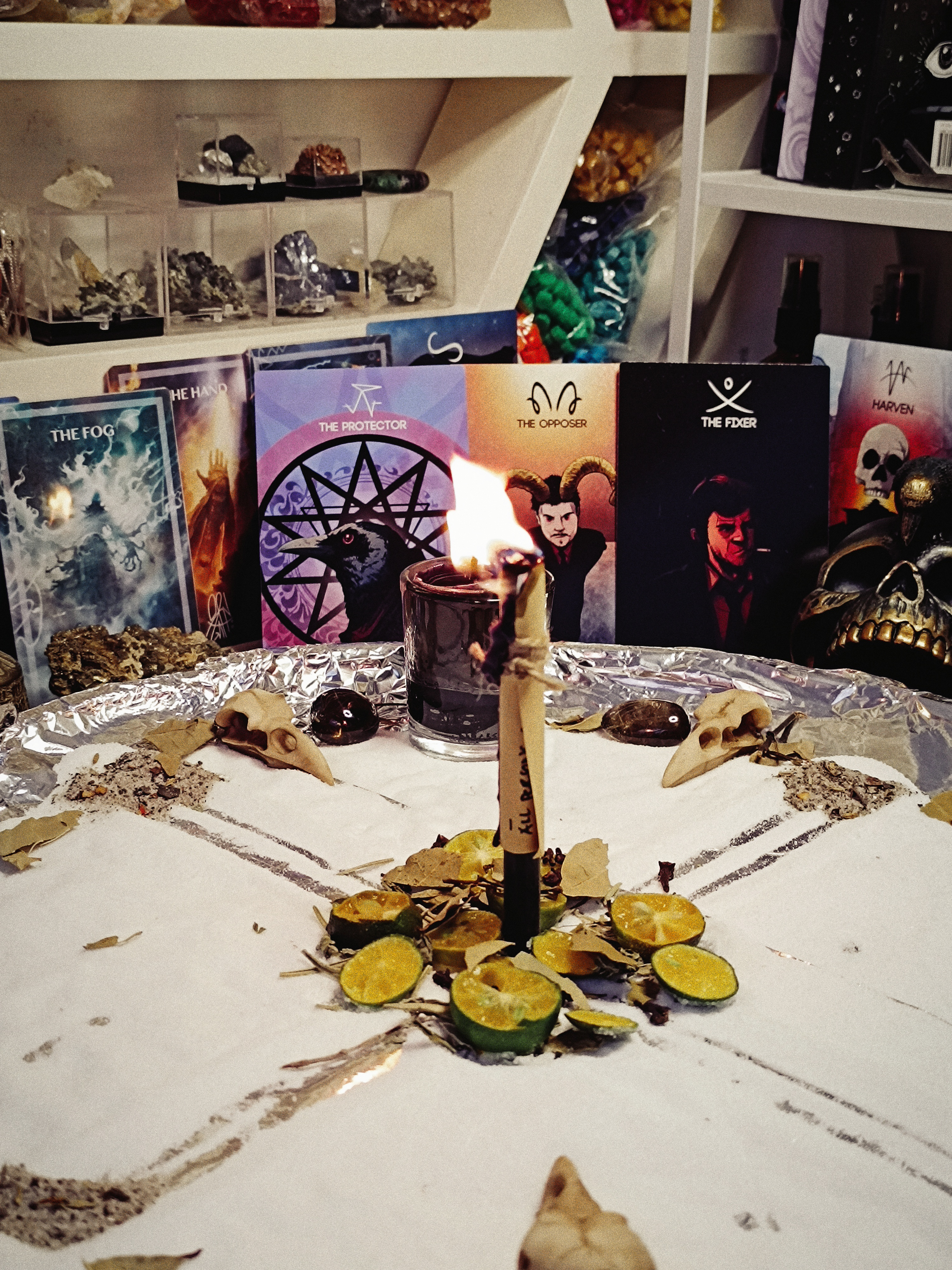 Closer view of The Uncrossing working with its central candle burning before symbolic cards