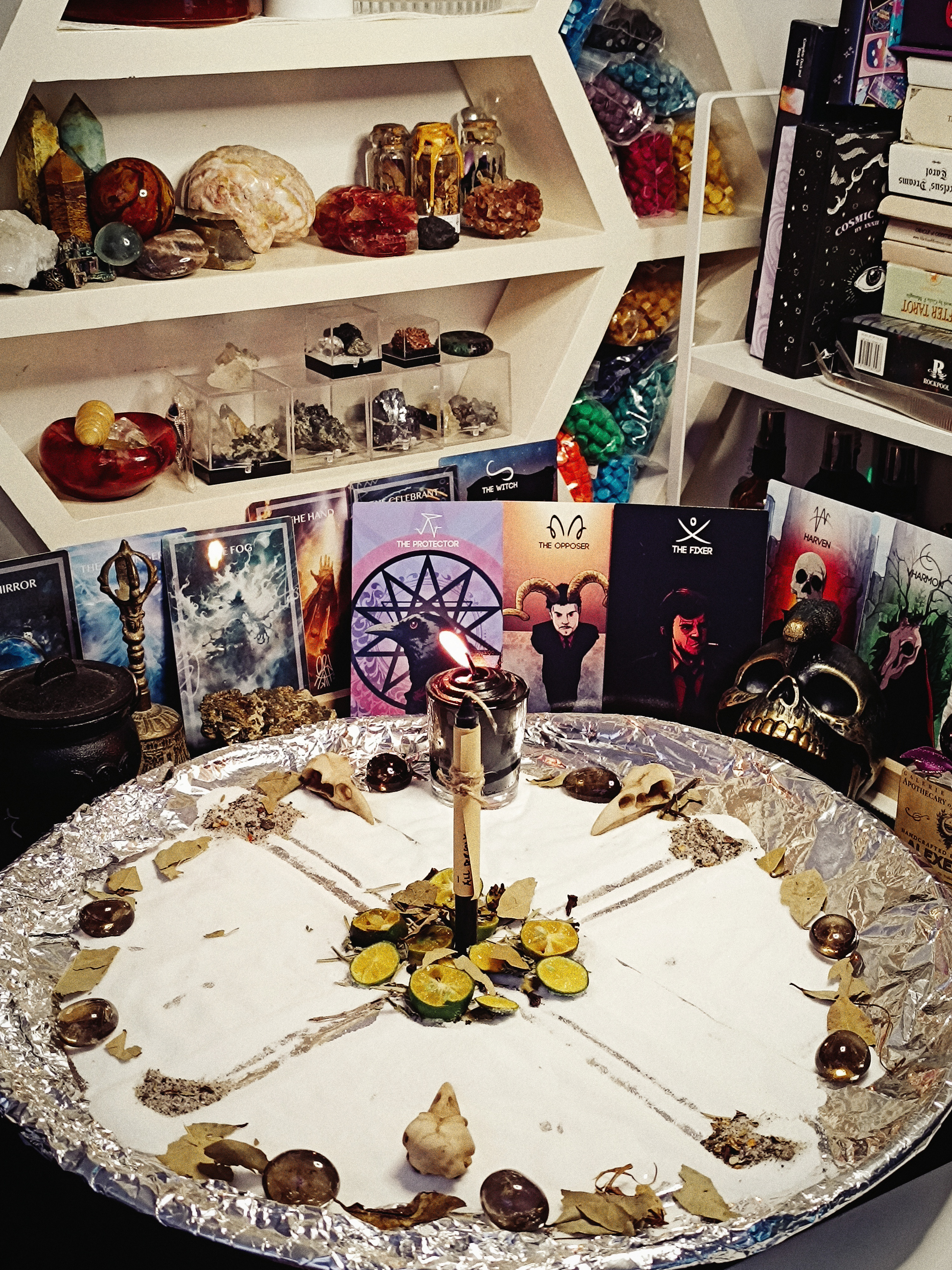 The Uncrossing ritual arranged with a central candle, cards, herbs, and protective stones