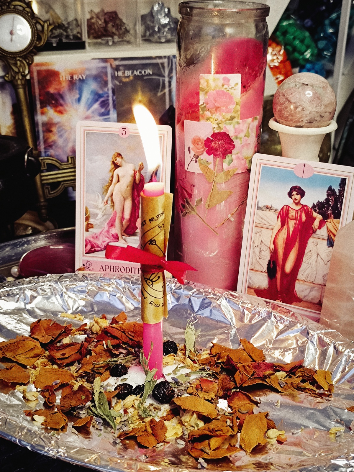 The Venus in Bloom ritual with a lit petition candle, roses, crystals, and Aphrodite imagery at the Galerie Rberry altar